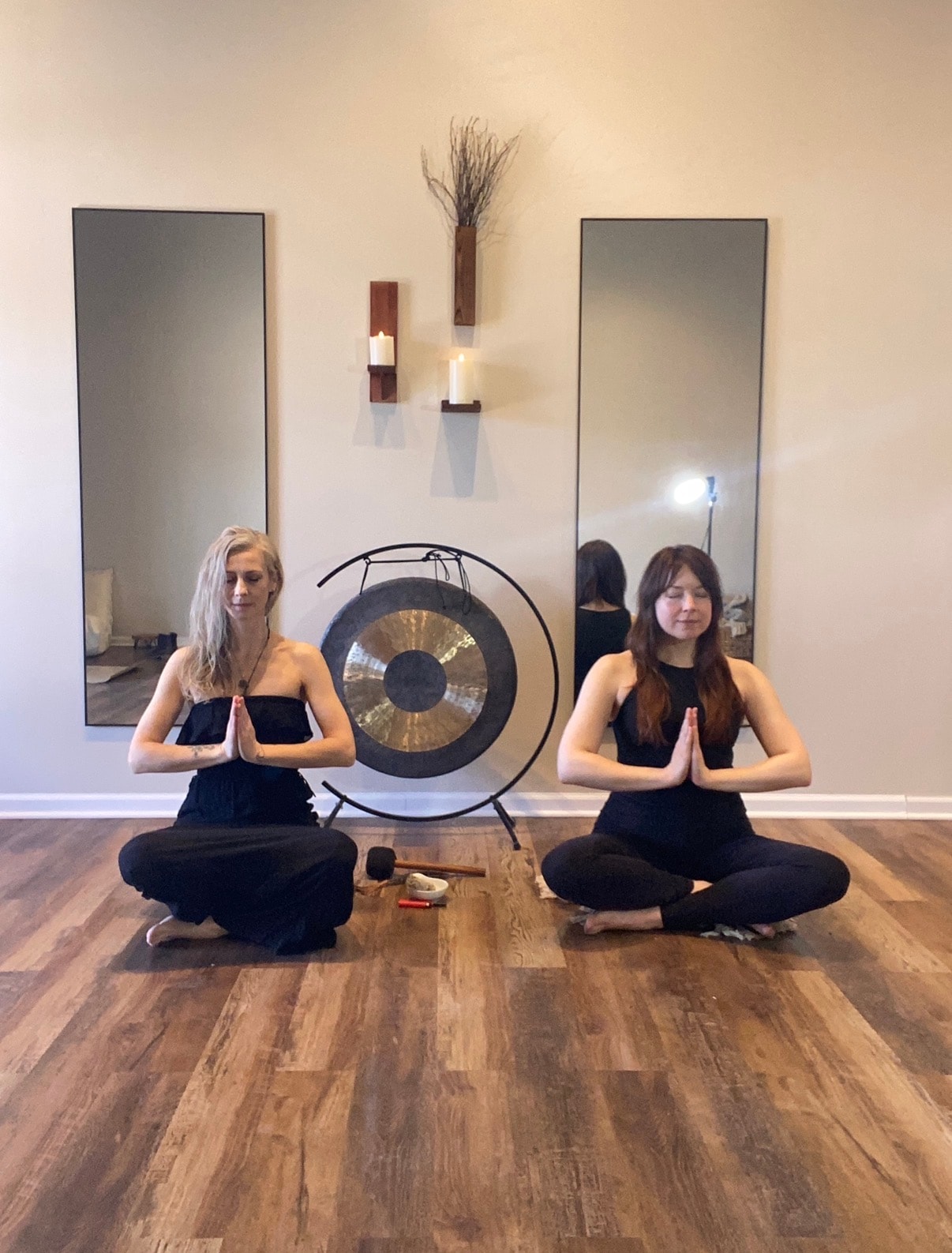 Sound bath and gong meditation at Mindful Way Studio — two women in prayer pose with gong in holistic wellness studio near Tinley Park IL